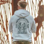 Hoodie featuring World War II design of two soldiers standing before a parachute jump
