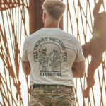 tshirtfeaturing World War II design of two soldiers standing before a parachute jump