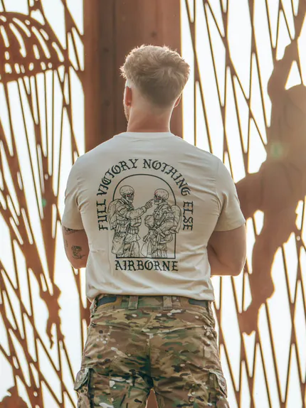 tshirtfeaturing World War II design of two soldiers standing before a parachute jump
