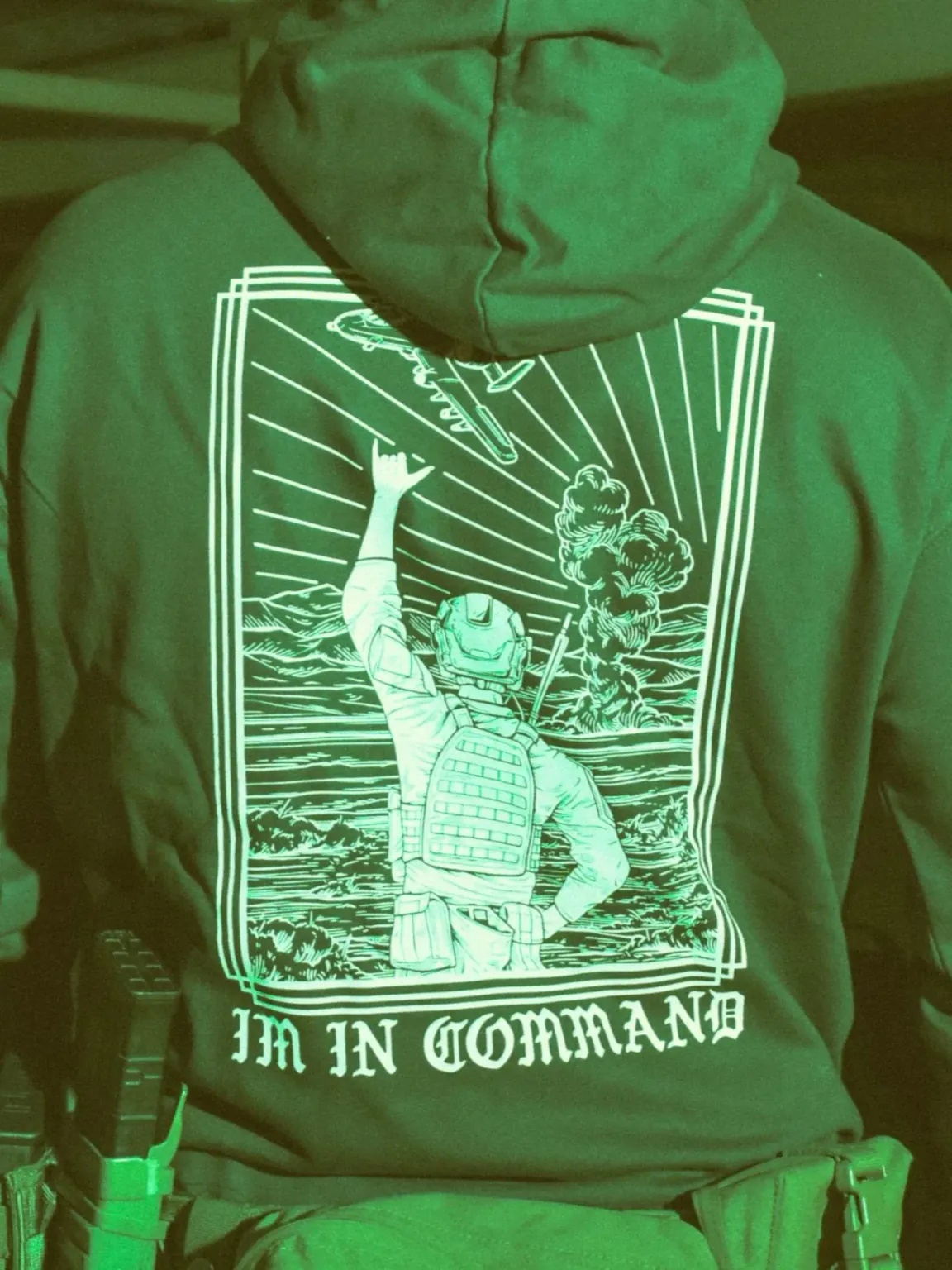 the trace apparel collection featuring a fst jtac guy standing in front of a firing plane