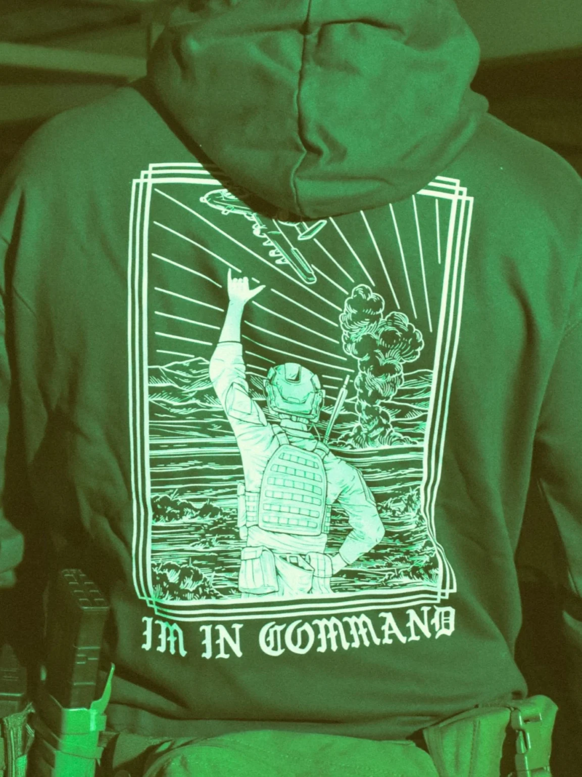 the trace apparel collection featuring a fst jtac guy standing in front of a firing plane
