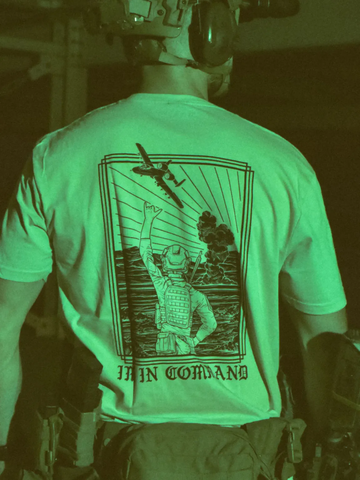 the trace apparel collection featuring a fst jtac guy standing in front of a firing plane