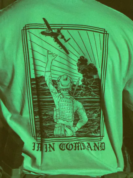 the trace apparel collection featuring a fst jtac guy standing in front of a firing plane