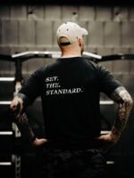 Black T-shirt from The Trace featuring Set the Standard design symbolizing the pursuit of the highest performance