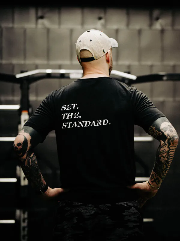Black T-shirt from The Trace featuring Set the Standard design symbolizing the pursuit of the highest performance