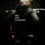Black hoodie from The Trace featuring Set the Standard design symbolizing the pursuit of the highest performance