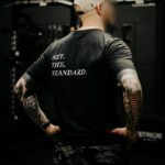 Black T-shirt from The Trace featuring Set the Standard design symbolizing the pursuit of the highest performance