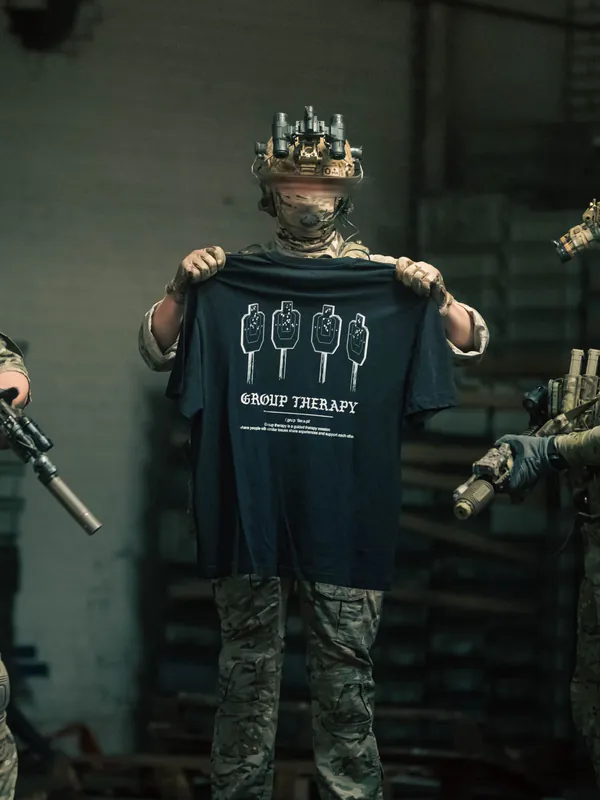 Black tshirt from The Trace featuring Group Therapy design with four targets marked by tight bullet hole groupings