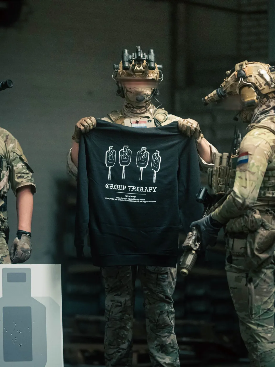 Black hoodie from The Trace featuring Group Therapy design with four targets marked by tight bullet hole groupings