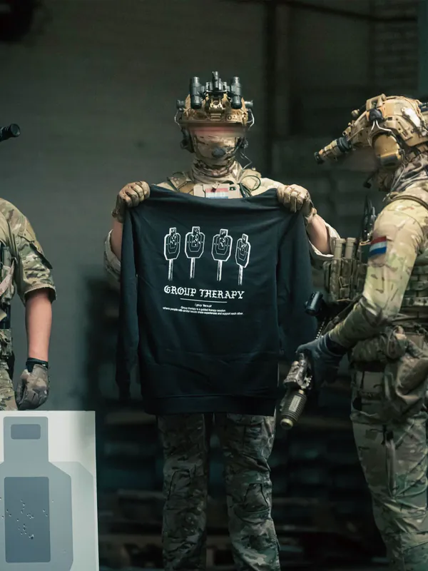Black hoodie from The Trace featuring Group Therapy design with four targets marked by tight bullet hole groupings