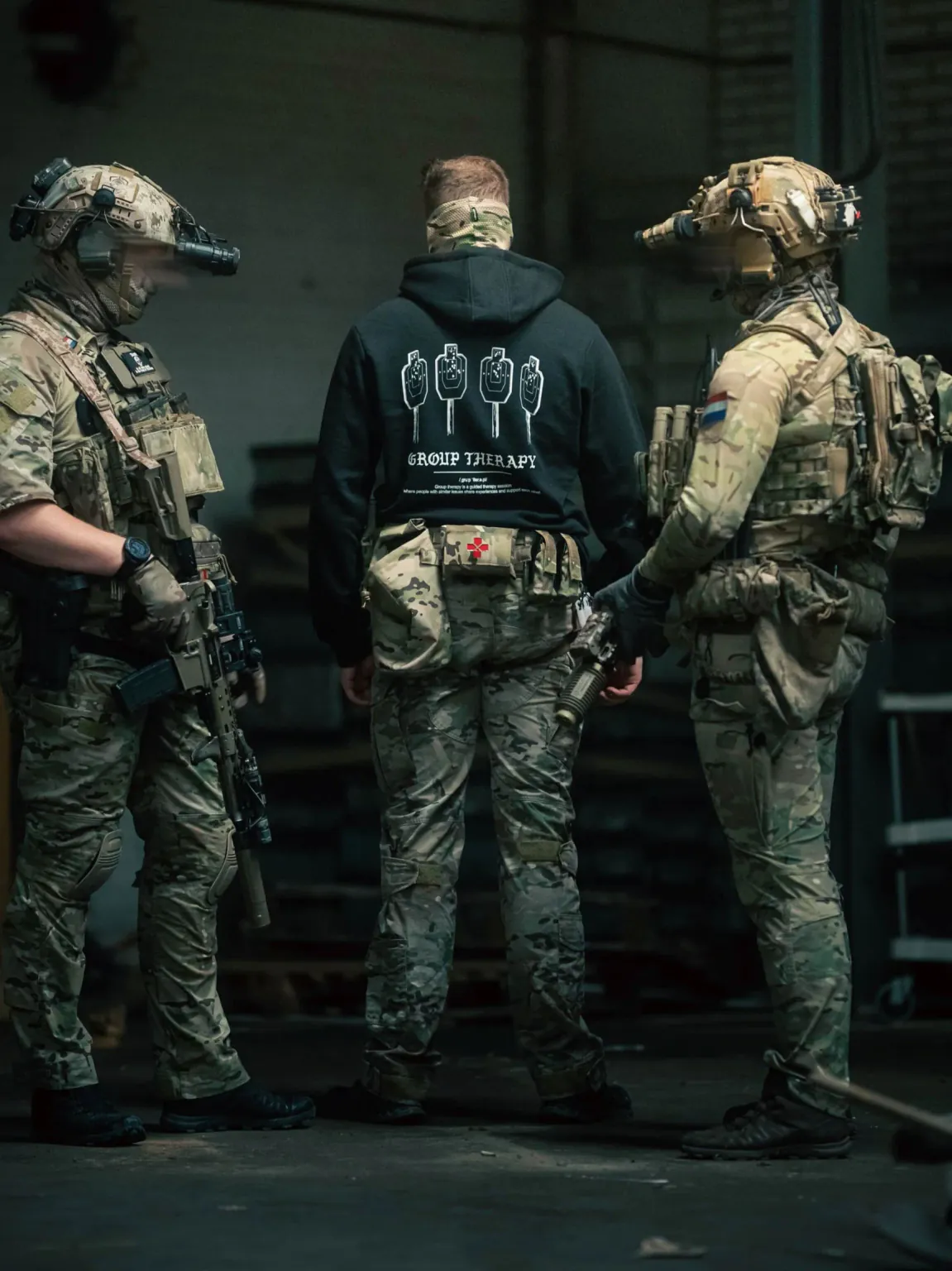 Black hoodie from The Trace featuring Group Therapy design with four targets marked by tight bullet hole groupings