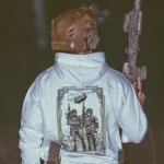 the trace apparel collection featuring 2 air assault operators standing in front of a chinook