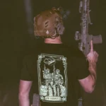 the trace apparel collection featuring 2 air assault operators standing in front of a chinook
