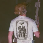 the trace apparel collection featuring 2 air assault operators standing in front of a chinook
