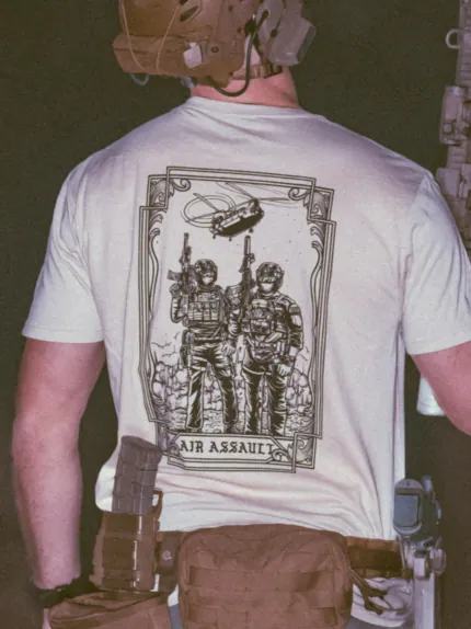 the trace apparel collection featuring 2 air assault operators standing in front of a chinook