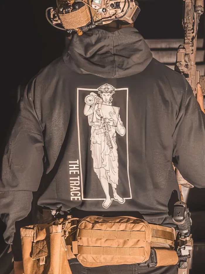 black hoodie featuring a girl carrying an anti tank weapon.