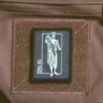 the trace apparel collection patch featuring a woman holding a anti tank weapon
