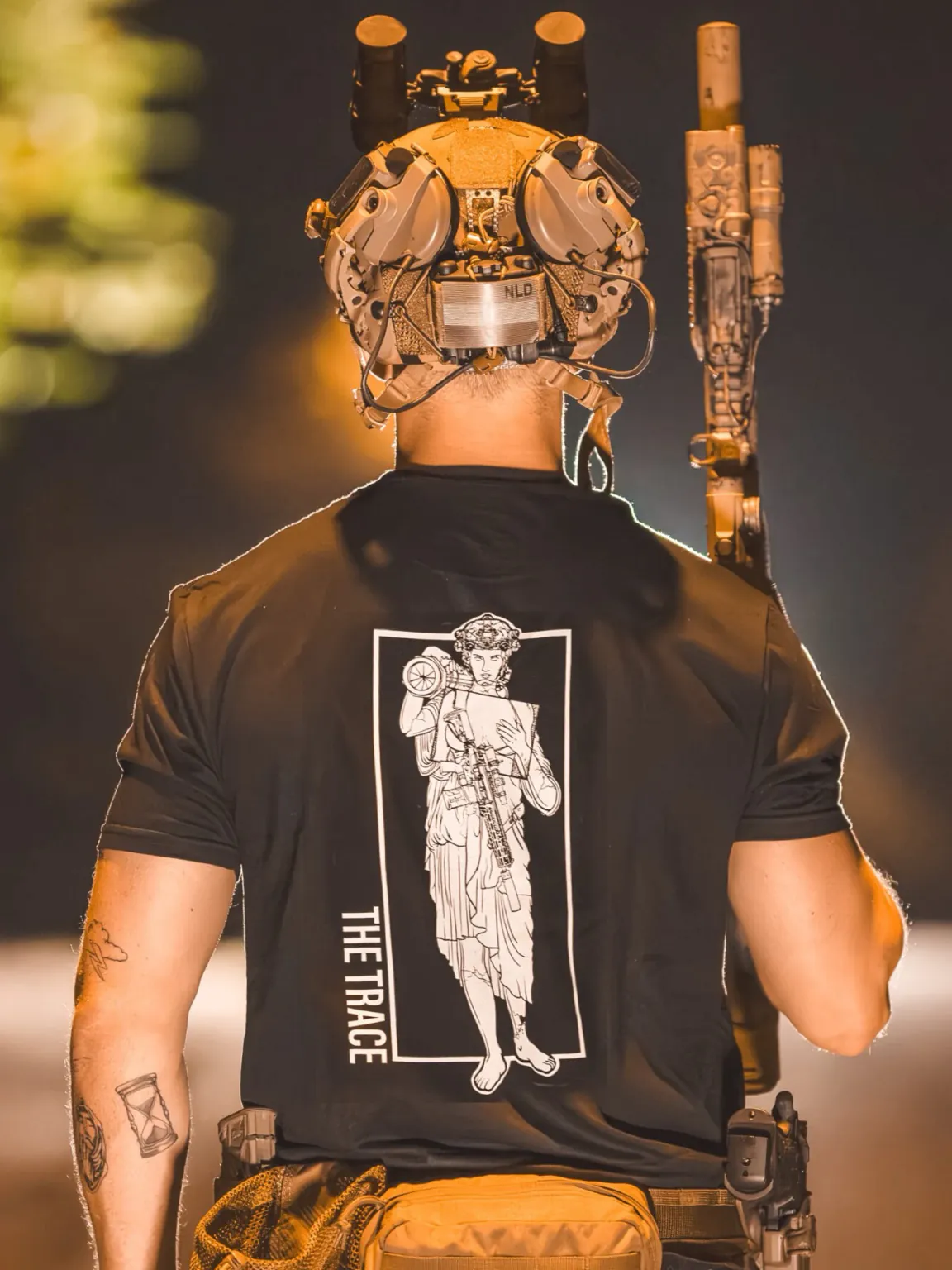 black shirt featuring a girl carrying an anti tank weapon.