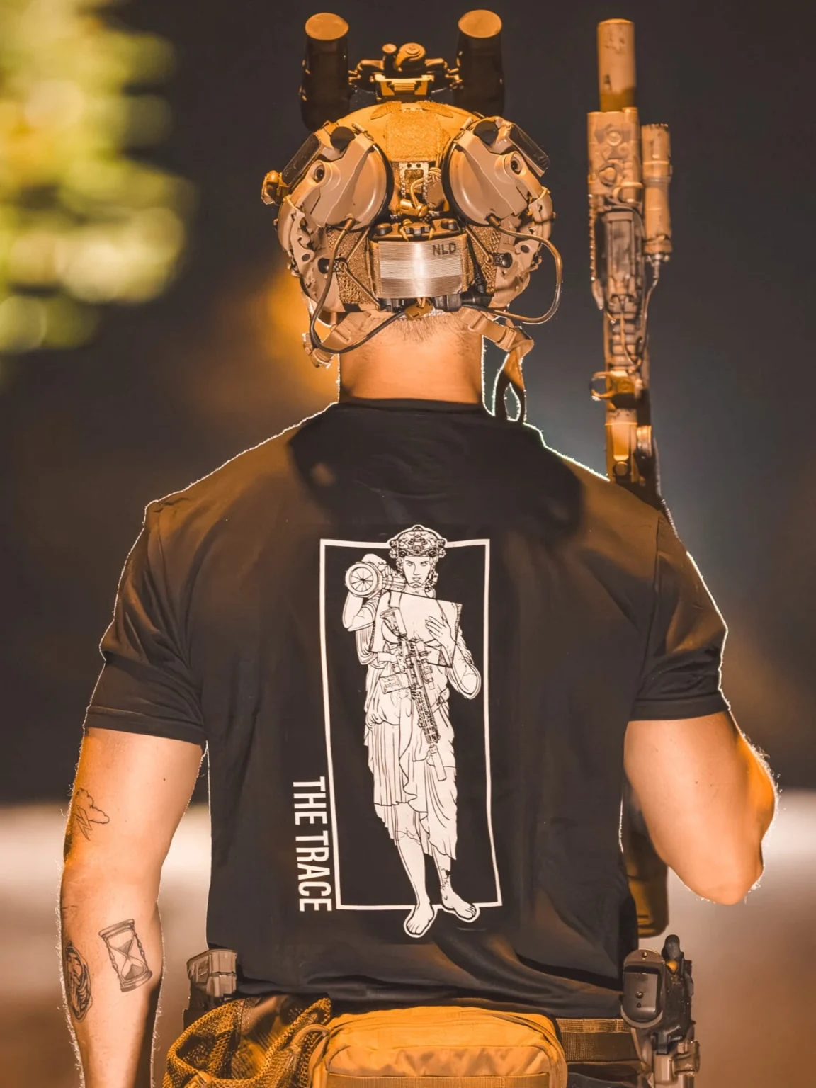 At4-statue-shirt black shirt featuring a girl carrying an anti tank weapon.