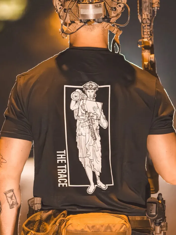black shirt featuring a girl carrying an anti tank weapon.