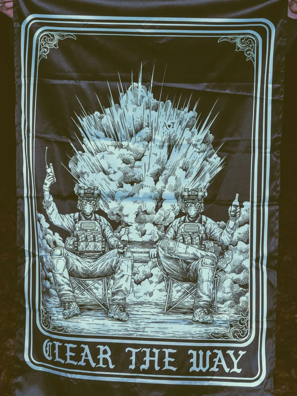 the trace apparel collection with 2 guys sitting in front of a explosing because they are part of the eod