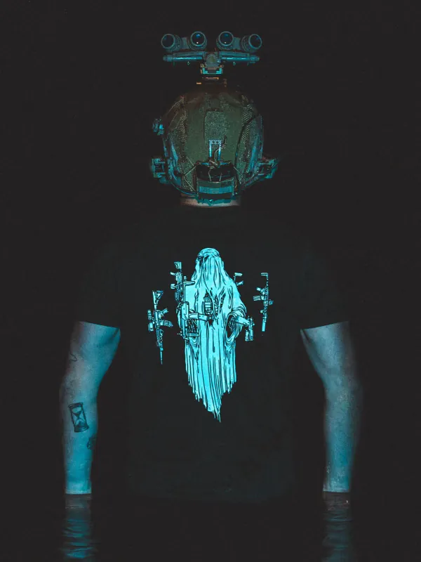 Halloween Ghost Tee by The Trace, shot at night under blue light, the real print is white