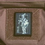 the trace apparel collection patch featuring a woman holding a machine gun