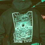 Military-style hoodie featuring the Saving Lives design: a group of soldiers carrying a stretcher while a helicopter prepares to land, symbolizing courage under pressure.