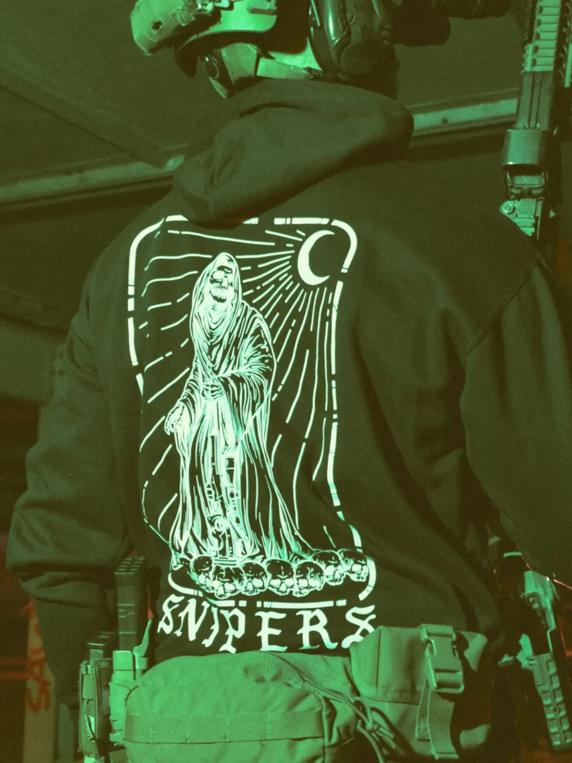 Sniper-black-hoodie-edit Sniper-themed military hoodie featuring a skeleton standing on skulls, armed with an Accuracy International Arctic Warfare Super Magnum.