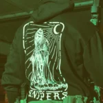 Sniper-themed military hoodie featuring a skeleton standing on skulls, armed with an Accuracy International Arctic Warfare Super Magnum.