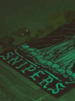 Combat flag displaying a sniper skeleton atop skulls, gripping an Arctic Warfare Super Magnum in a bold, battlefield stance.