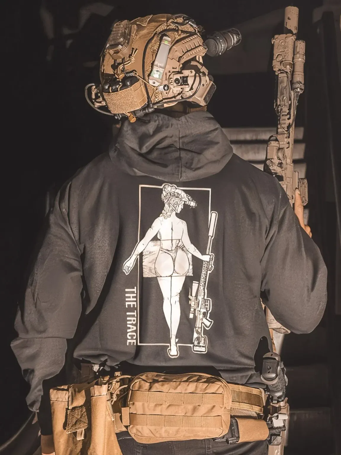 black hoodie featuring a girl carrying a sniper weapon.