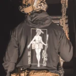 black hoodie featuring a girl carrying a sniper weapon.