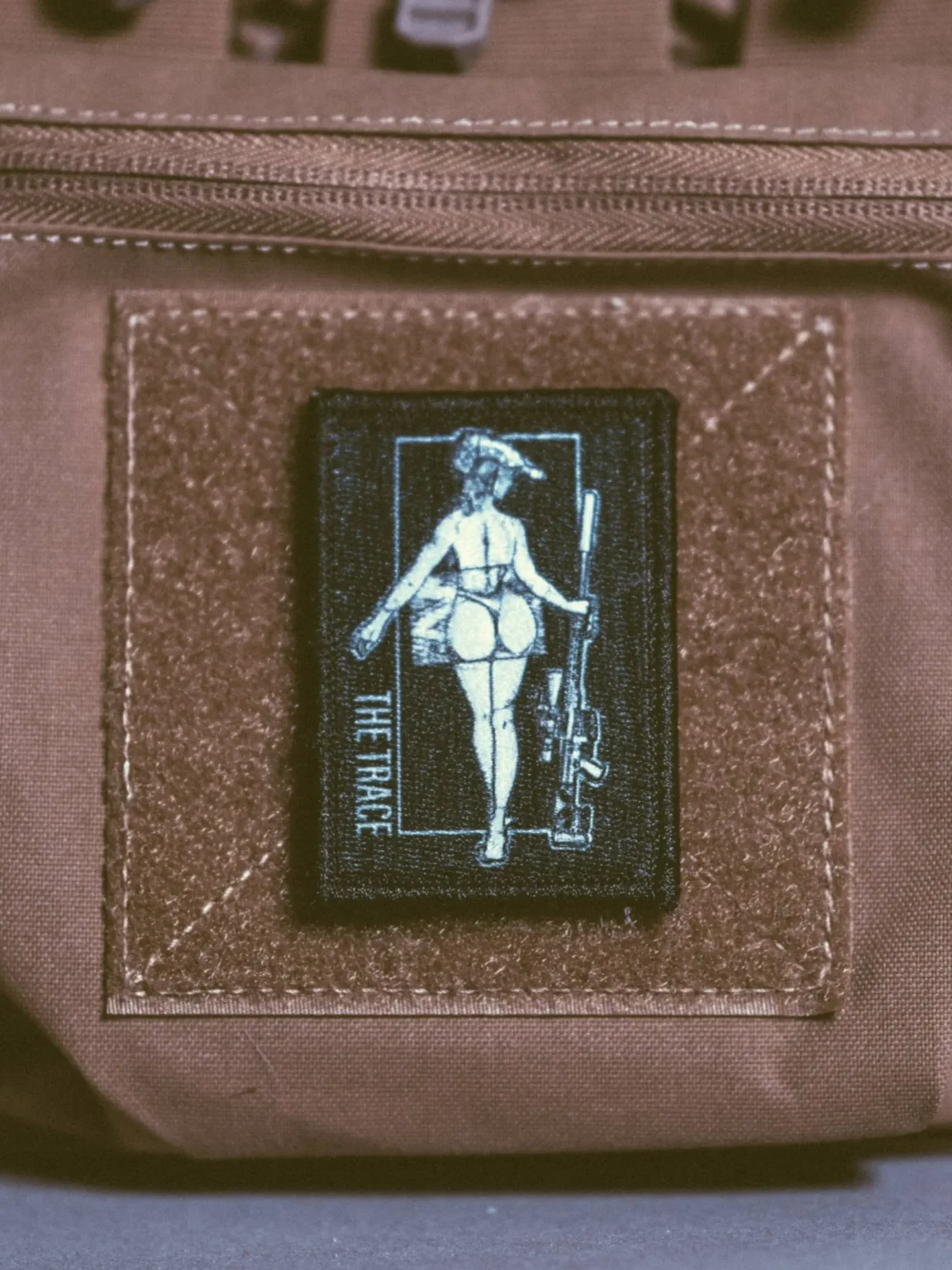 Sniper-statue-patch-edit_1 the trace apparel collection patch featuring a woman holding a sniper