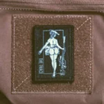 the trace apparel collection patch featuring a woman holding a sniper