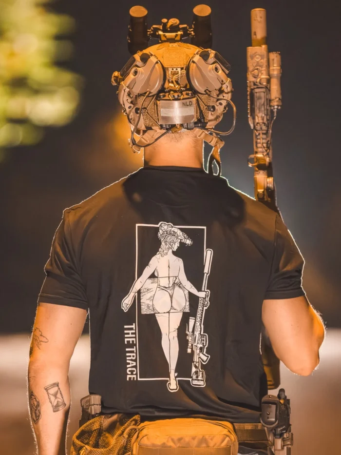 black tshirt from The Trace featuring a girl carrying a sniper weapon.