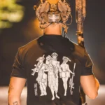 black shirt from The Trace featuring 3 girls carrying a machinegun sniperrifle and anti tank weapon