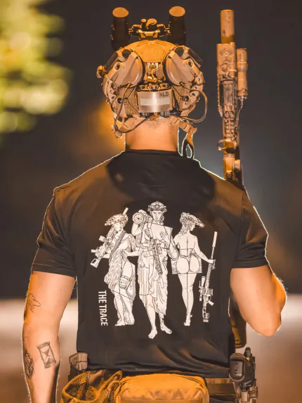 black shirt from The Trace featuring 3 girls carrying a machinegun sniperrifle and anti tank weapon