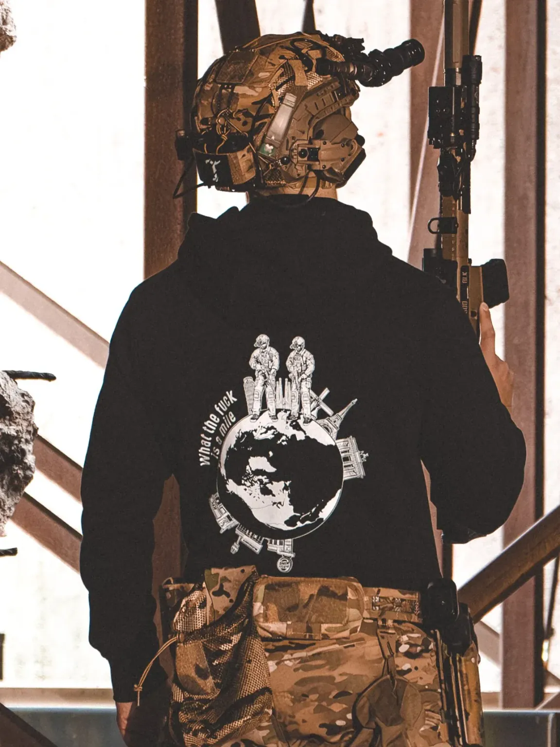 Wtf-is-a-mile-black-hoodie-edit the trace apparel collection featuring 2 operators standing on europe and watching america saying wtf is a mile