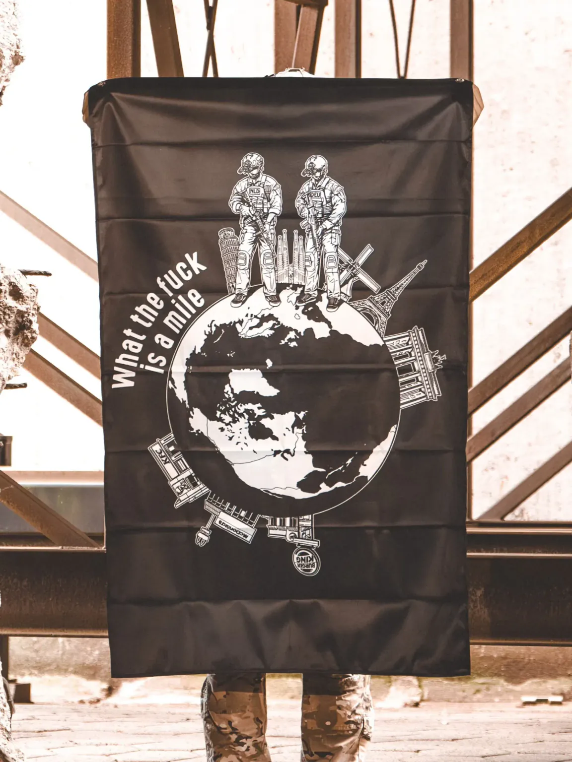 Wtf-is-a-mile-flag-edit the trace apparel collection featuring 2 operators standing on europe and watching america saying wtf is a mile