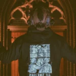 the trace apparel collection featuring a military and a police guy standing in front of a tinted window that displays saint michael the protector