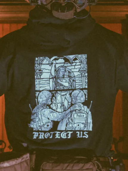 the trace apparel collection featuring a military and a police guy standing in front of a tinted window that displays saint michael the protector