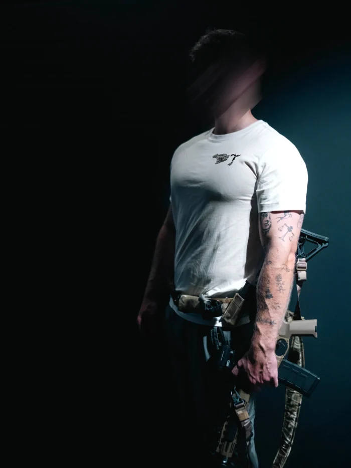 the trace mockup clothing featuring their T logo on the chest and a weapon on the hand
