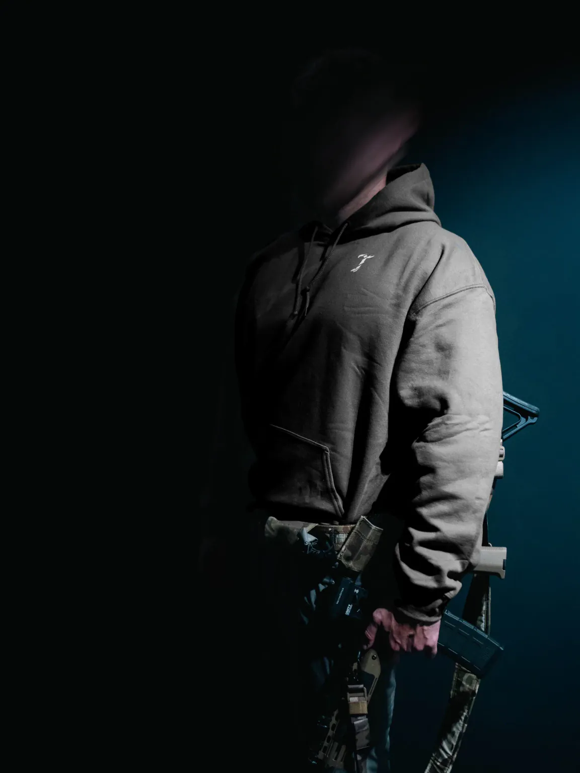 Charcoal hoodie by The Trace on a model, seen from the front side with the small T logo on the chest