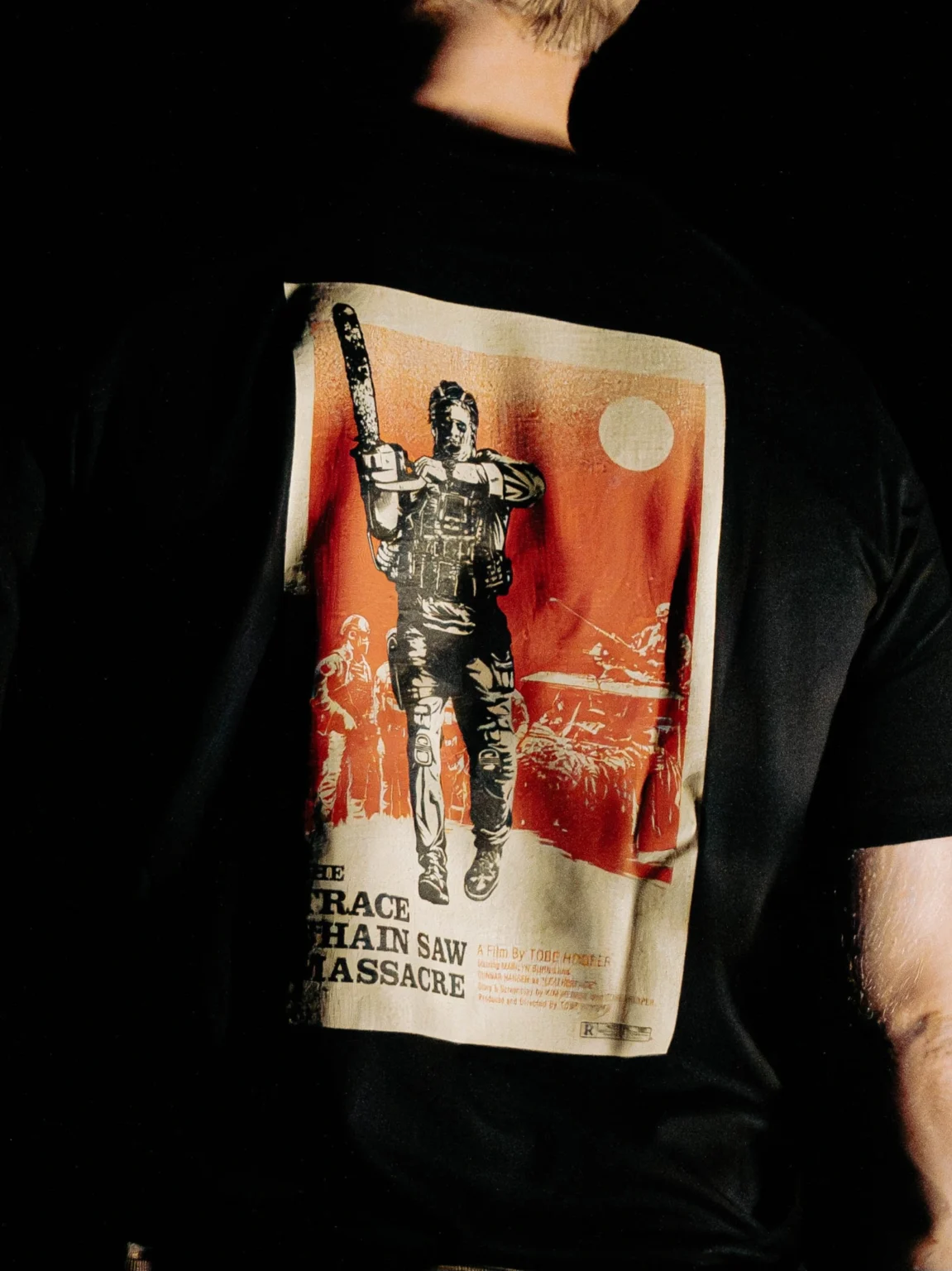 Close-up of the Chainsaw Massacre back print on the black The Trace T-shirt
