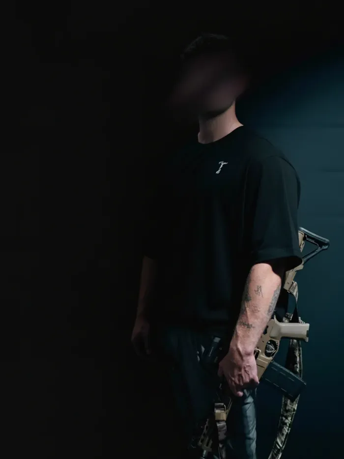 Black oversized T-shirt by The Trace on a model, seen from the front side with the small T logo on the chest