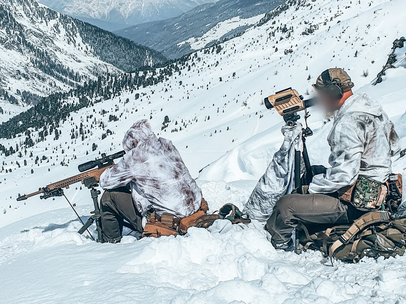 Dutch sniper and spotter in snow camouflage overlooking an alpine valley in Austria
