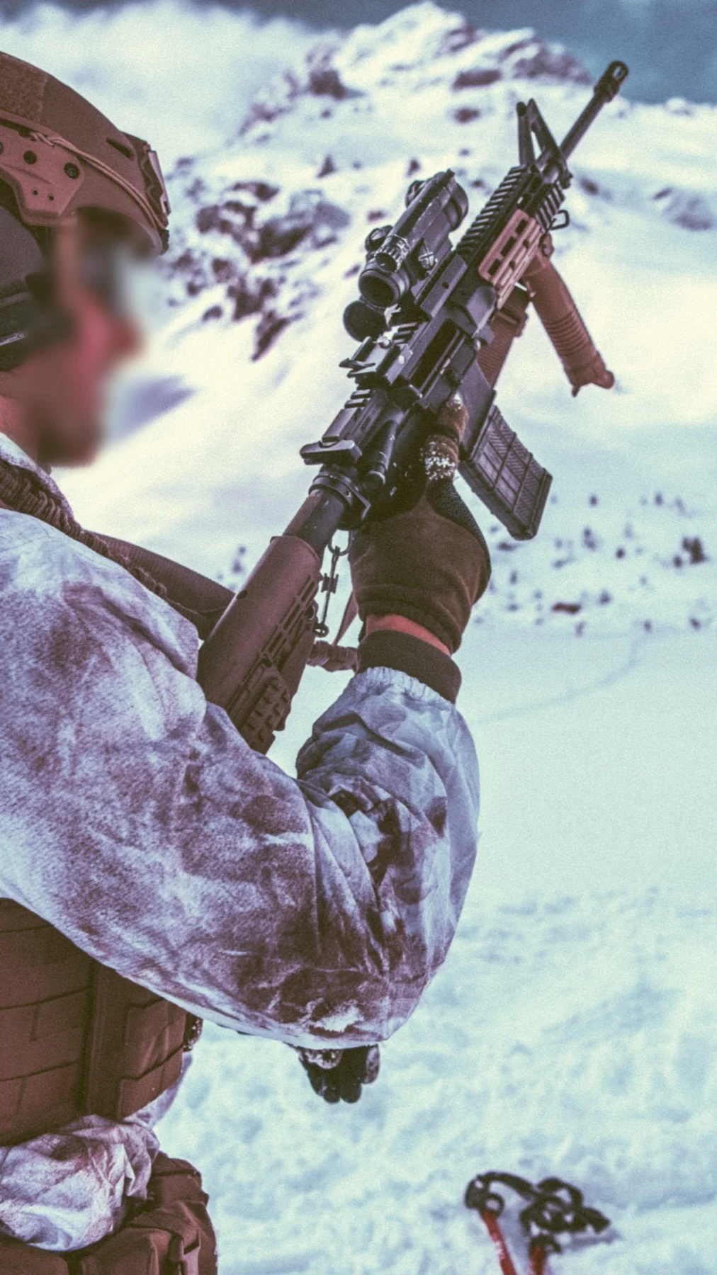 Dutch sniper in snow camouflage holding a rifle high in the Austrian mountains