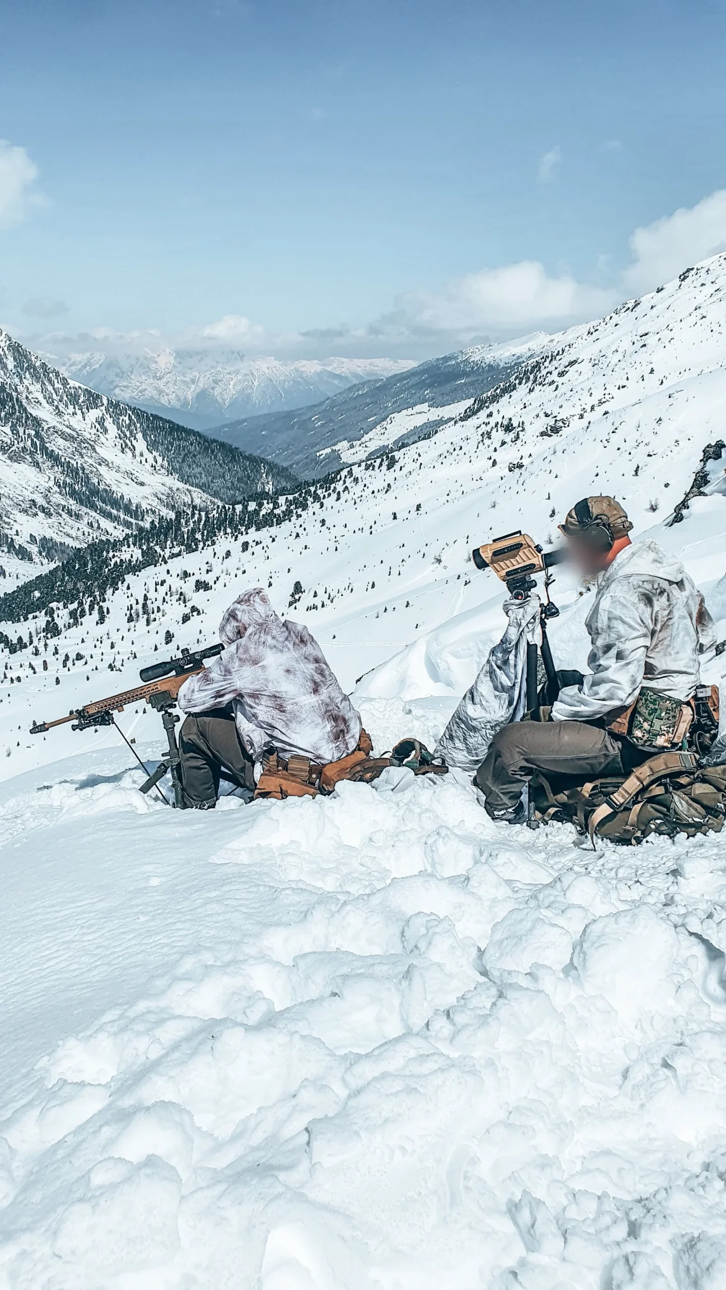 Dutch sniper and spotter in snow camouflage overlooking an alpine valley