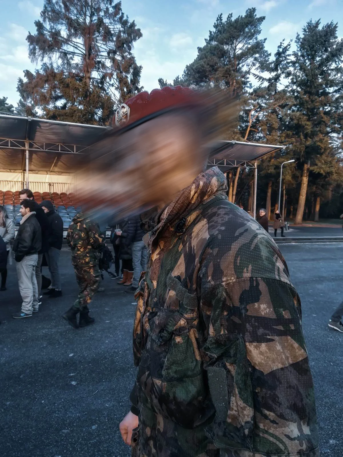 Dutch airmobile soldier in woodland camouflage wearing the red beret for the first time on the parade square